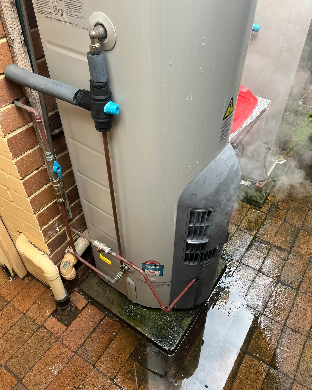 Hot-water storage unit and connections during an inspection and service